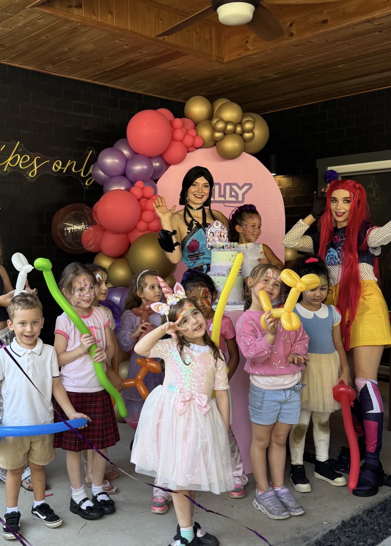 Children celebrating with colorful entertainers