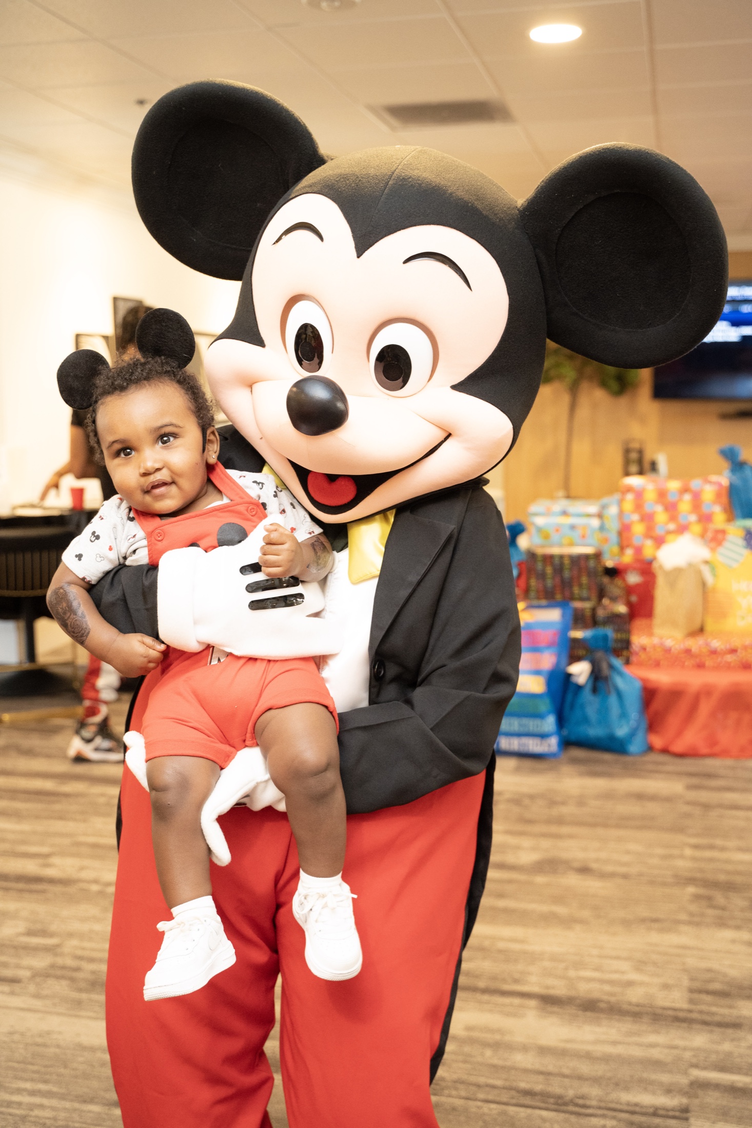 Mascot holding a smiling child